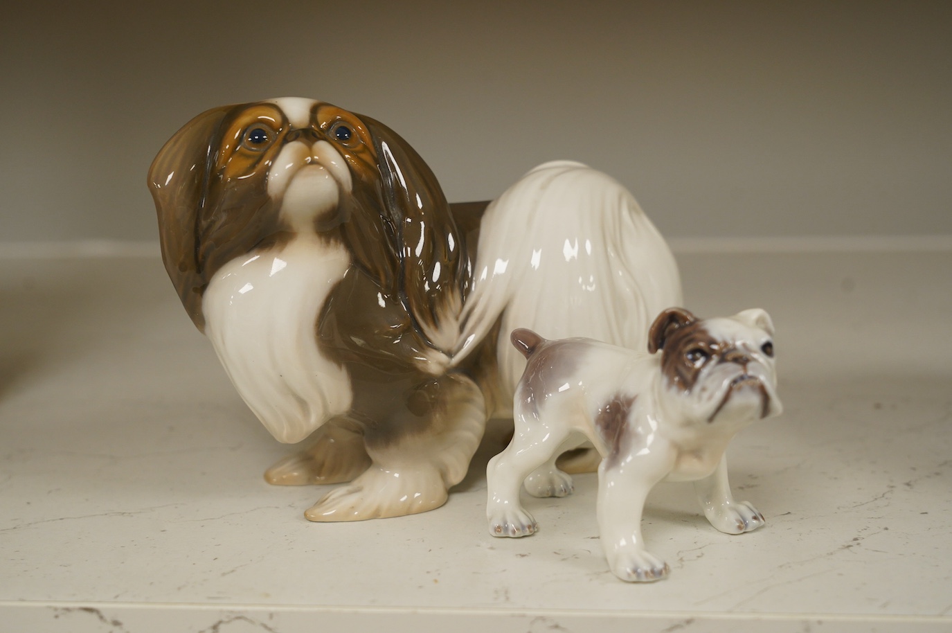 An early Bing & Grondahl figure of a Japanese Chin 12cm high, and a Dahl Jensen small bulldog, 7cm high. Condition - good